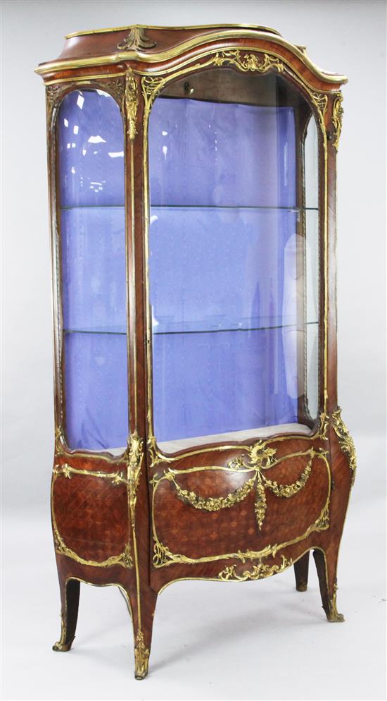 A Louis XVI style ormolu mounted kingwood serpentine vitrine, W.3ft 8in. D.1ft 8in. H.6ft 8in.